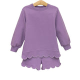 Purple children's outfit with scalloped hem on a white background