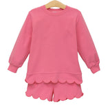 Pink children's outfit with scalloped hem on a white background