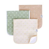 Three burp cloths stacked in an overlapping arrangement on a white background. The top cloth is beige with small white floral motifs, the middle is sage green with white starburst prints, and the bottom is cream with small yellow floral motifs.