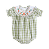 A baby romper in a light green and white gingham pattern, featuring a white embroidered collar with orange pumpkins and green vines, and ruffled short sleeves.