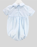 A light blue baby romper with a short-sleeve collar, buttoned front, and gathered waist, displayed on a white hanger against a solid gray background.