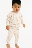 Baby wearing a cream-colored crewneck sweater set with mallard print on a white background.