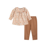 Children's floral top and brown pants set on a white background
