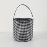 Black and white gingham bucket bag on a light gray background