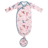 Baby knotted gown with cowboy print on a white background